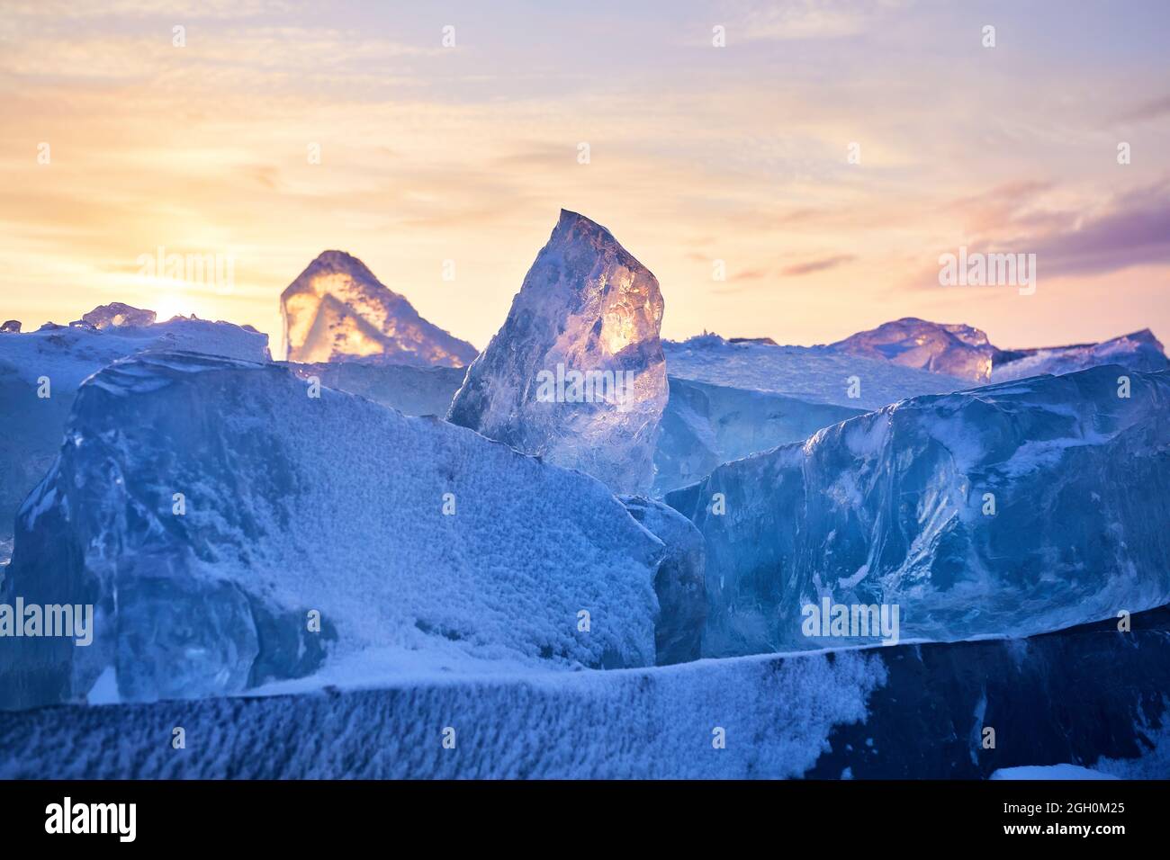 Beautiful sunset landscape of Ice hummock and cracks at frozen lake Baikal, Russia Stock Photo