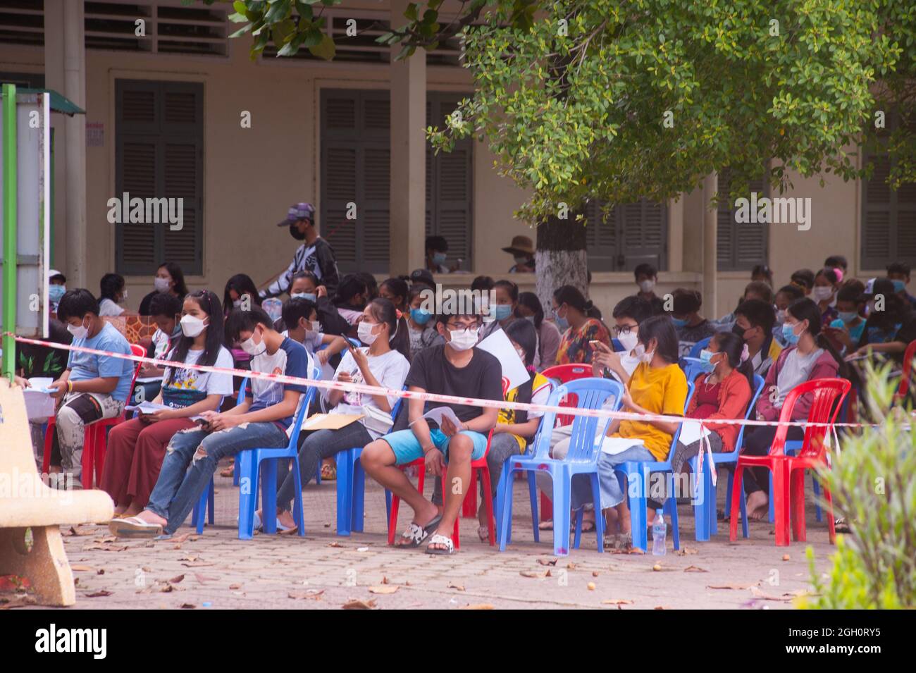 Phnom Penh, Cambodia. Sept. 4th, 2021. for over a 1/2 year Phnom Penh has been battling a COVID - 19 surge. the Cambodian government stays on course w/ its vaccination program for 12 through 17 year olds. teenagers, in protective face masks, wait their turn for inoculation. credit: Kraig Lieb / Alamy Live News. Stock Photo
