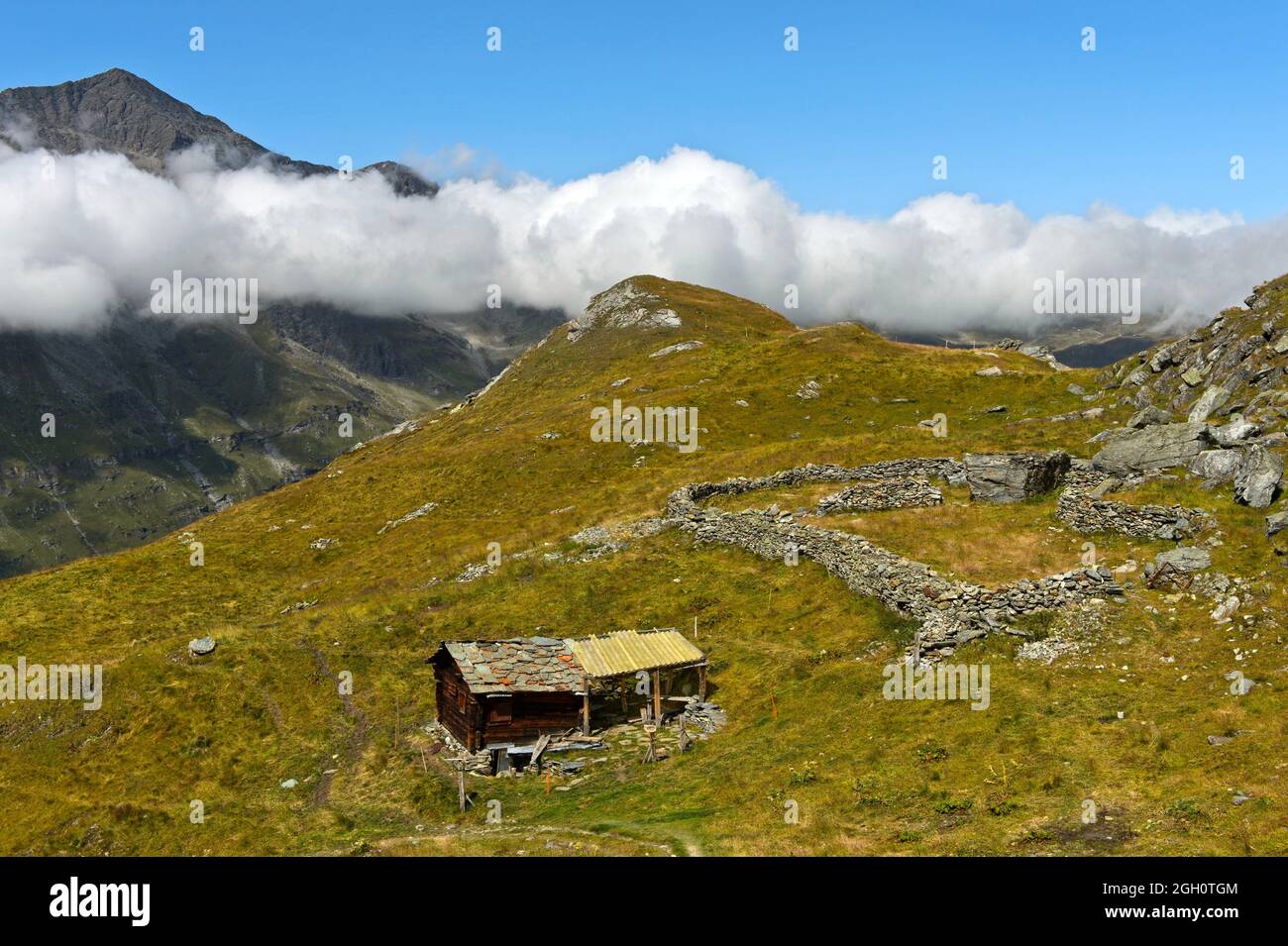 Alp with alpine hut and sheep pen, Val dâ.Anniviers, Zinal, Wallis, Switzerland. Stock Photo