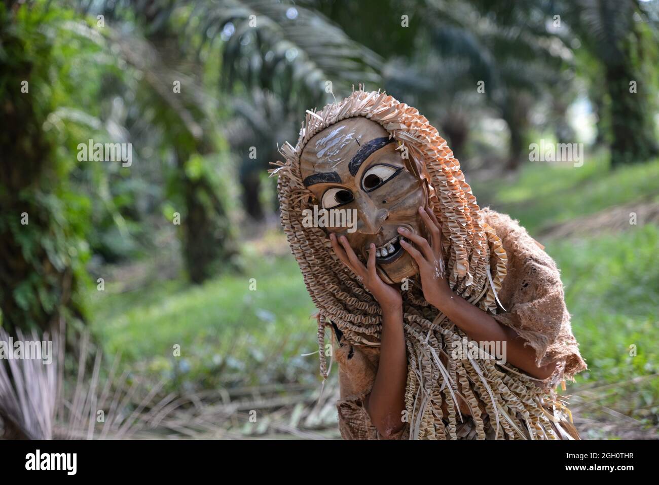 Carey Island, Selangor/Malaysia - Mar 17 2018: Malaysia aborigine Mah Meri with mask at oil palm estate,. Stock Photo