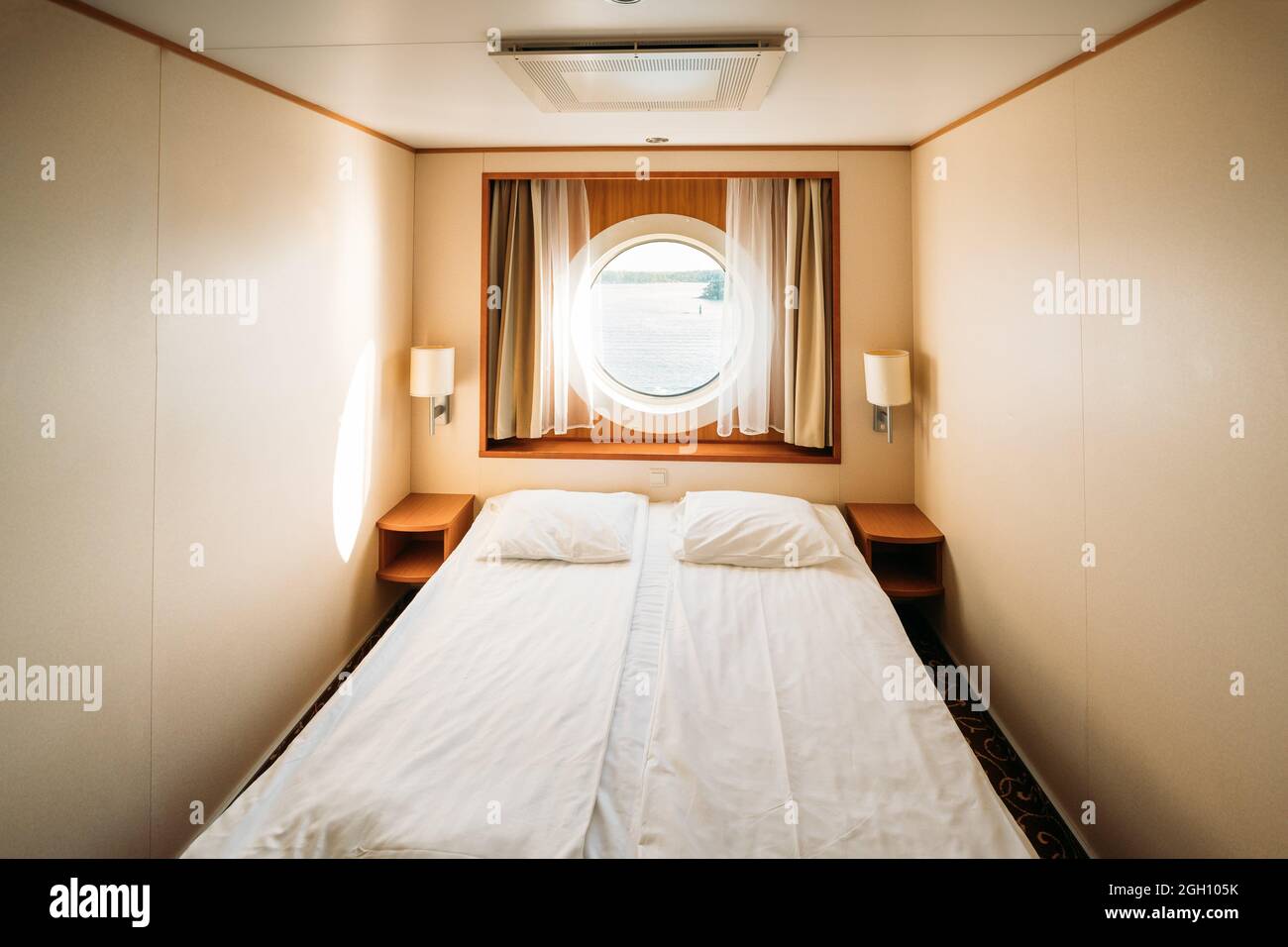 Ship Cabin With Bed And Window With View On Sea. Luxury Cabin On Ferry
