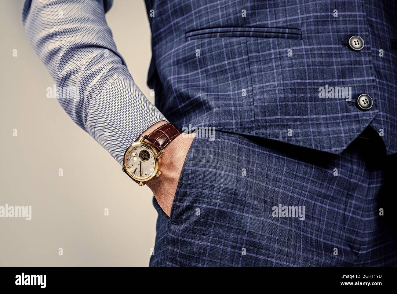 Punctuality is essential in the business world. Luxury watch worn on