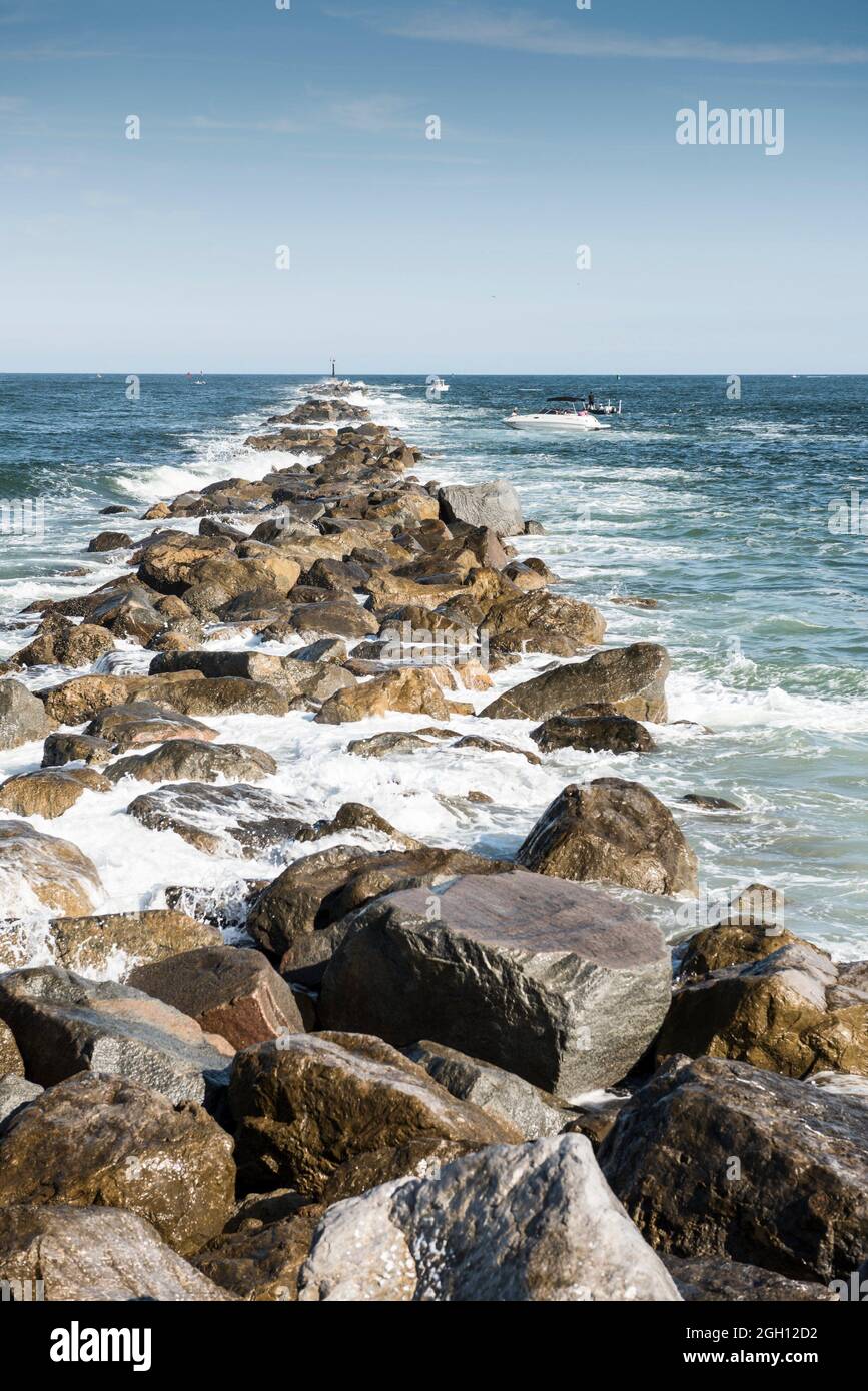 Fishing boats along a long stone jetty on Florida east coast, Ponce