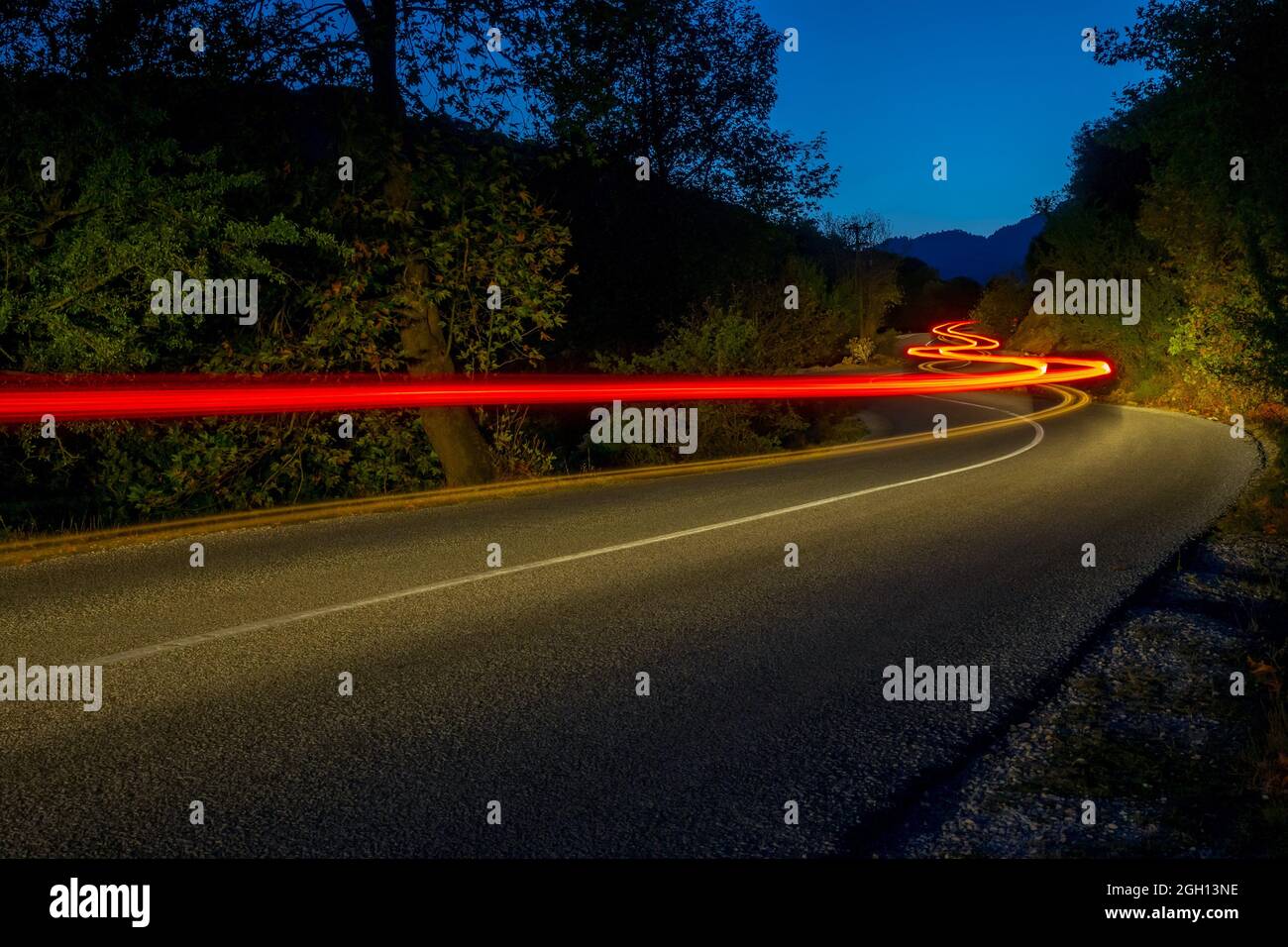 Taillights illuminate an empty road in 