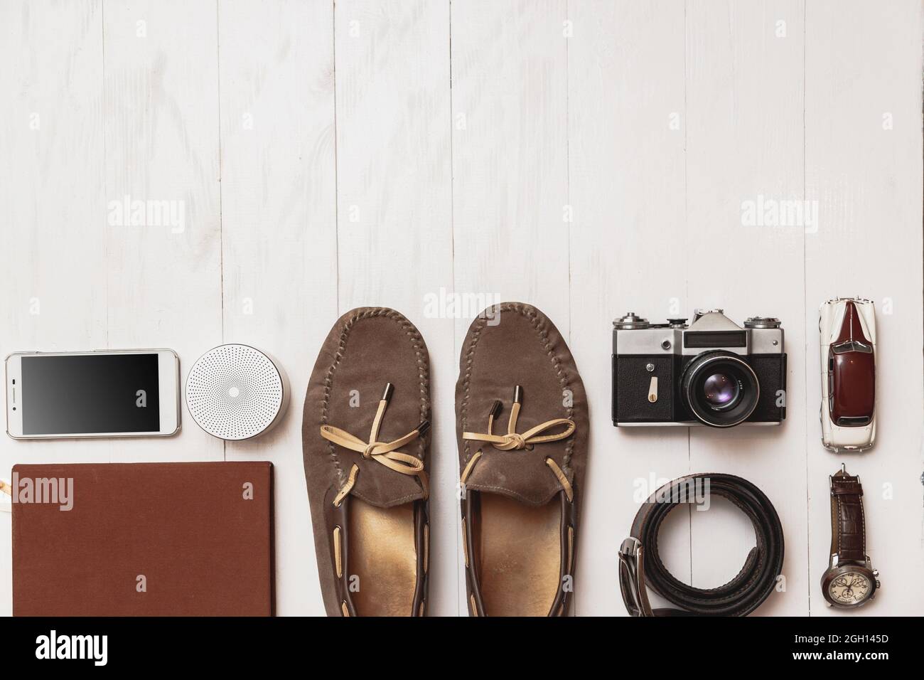 Set of men's blogger accessories for the traveler on a white wooden