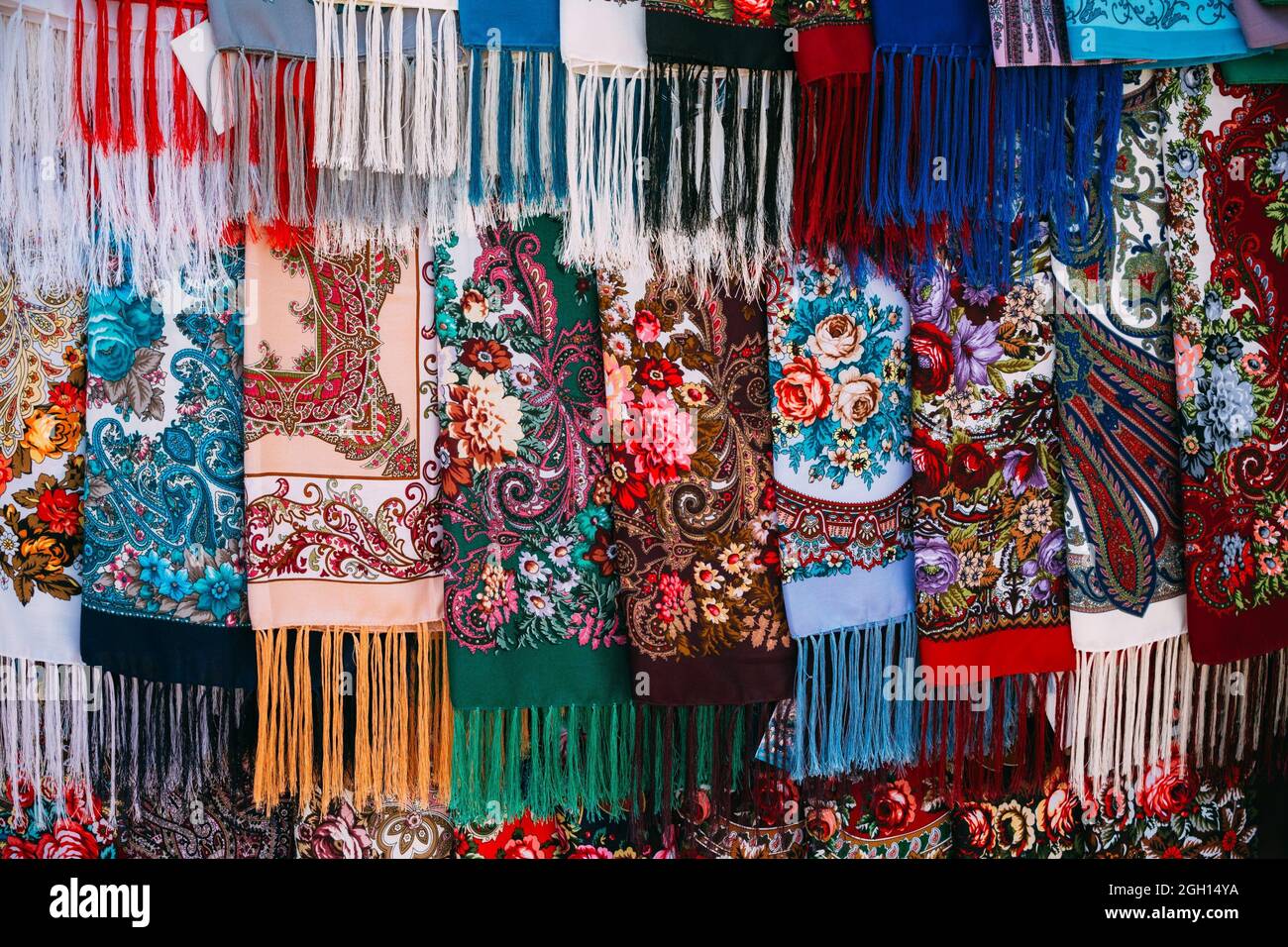 Rows of traditional Russian colorfull scarfs and headscarfs in market. Stock Photo