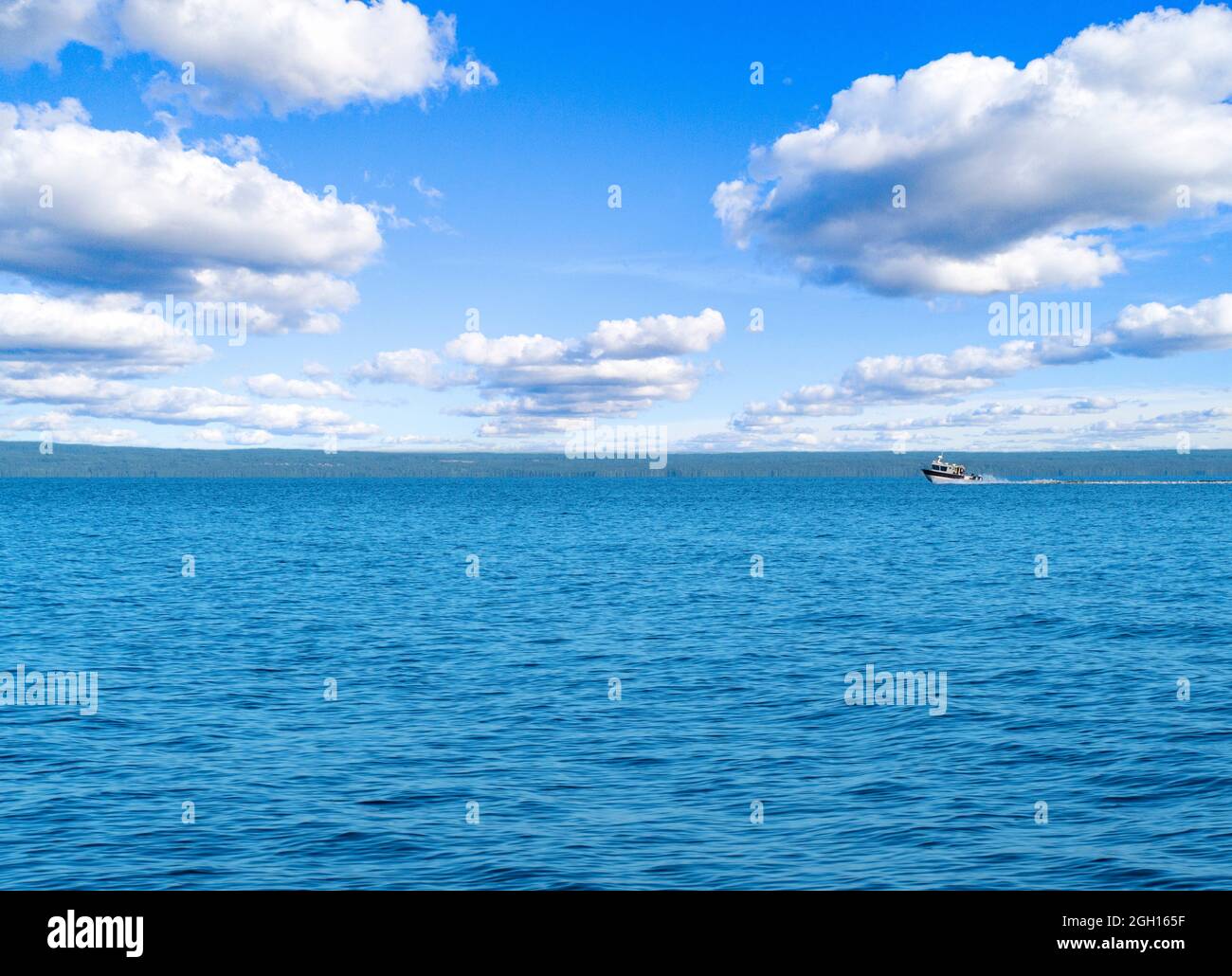 Speeding fishing motor boat with drops of water. Blue ocean sea water ...