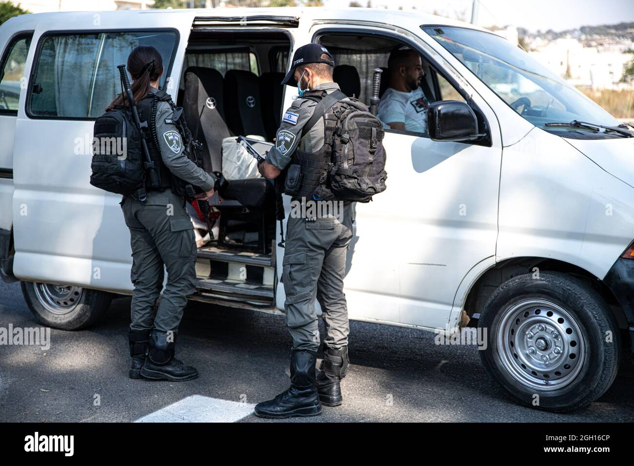 Armed Israeli Defense Forces soldiers of the Border Control unit, enforcing Covid-19 public transport restrictions in East Jerusalem. Giving fines to those who don't wear a mask. According to the bus drivers - this is a casual event in the last weeks in the Palestinian areas of the city. Palestine/Israel, Jerusalem. on September 3, 2021. (Photo by Matan Golan/Sipa USA) Credit: Sipa USA/Alamy Live News Stock Photo