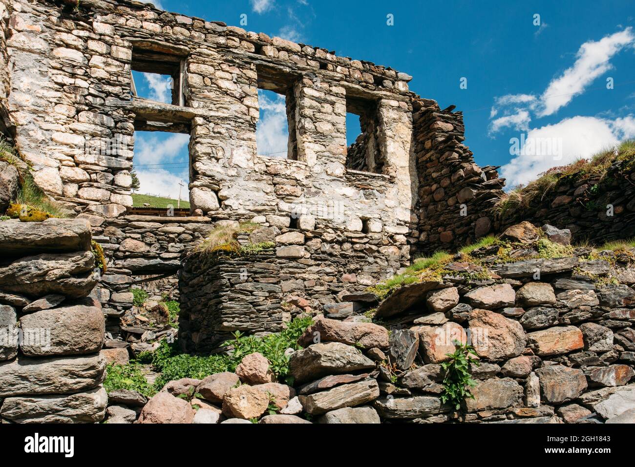 Stepantsminda Gergeti, Georgia. Old Abandoned Dilapidated Ruined House In Village. Kazbegi District, Mtskheta-Mtianeti Region, Georgia. Spring Or Stock Photo