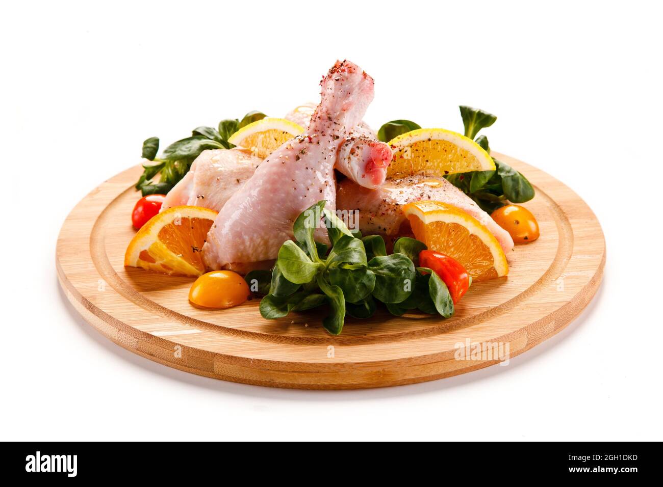 Raw pork chops on cutting board and vegetable. Stock Photo