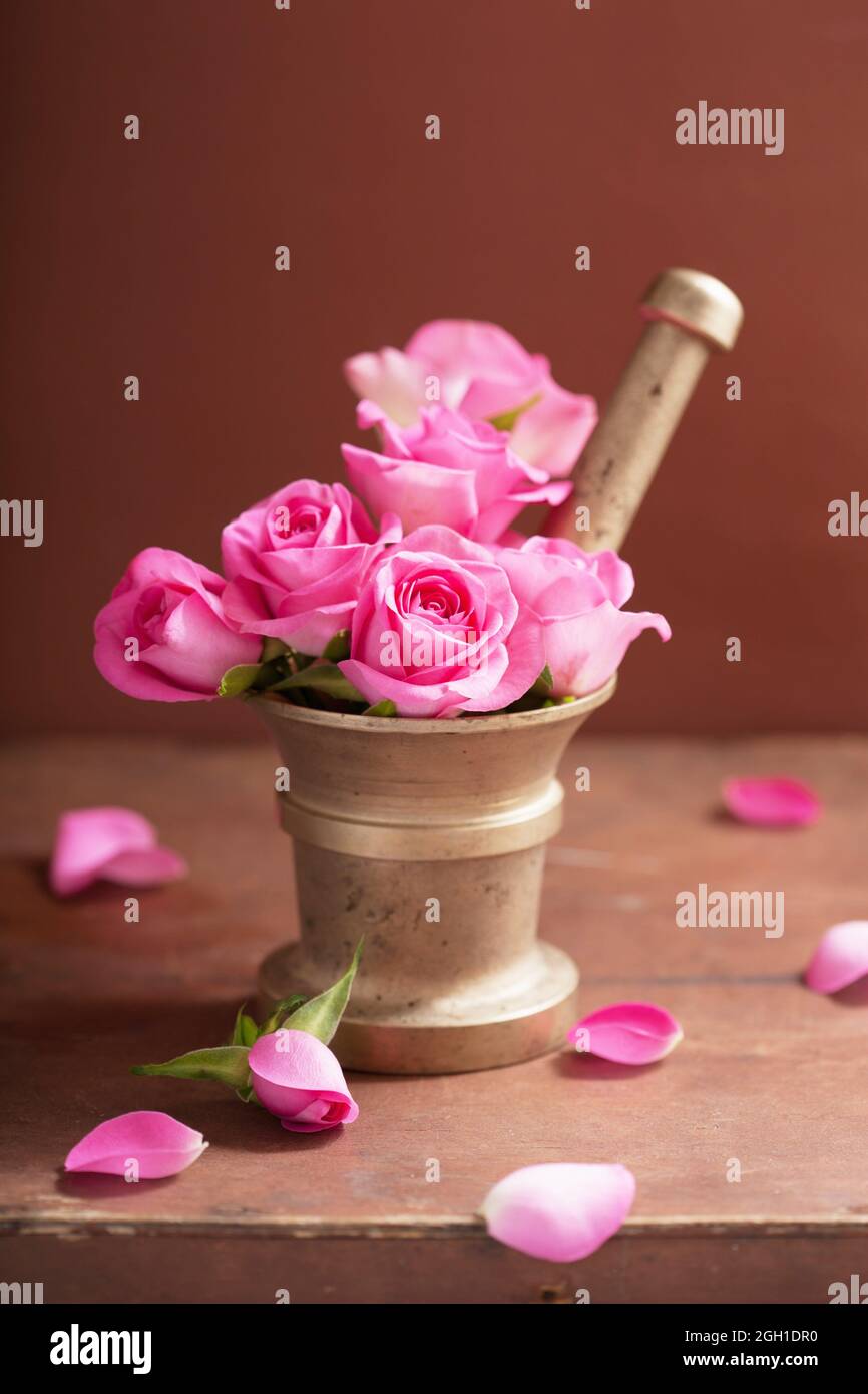 mortar with rose flowers for aromatherapy and spa. Stock Photo