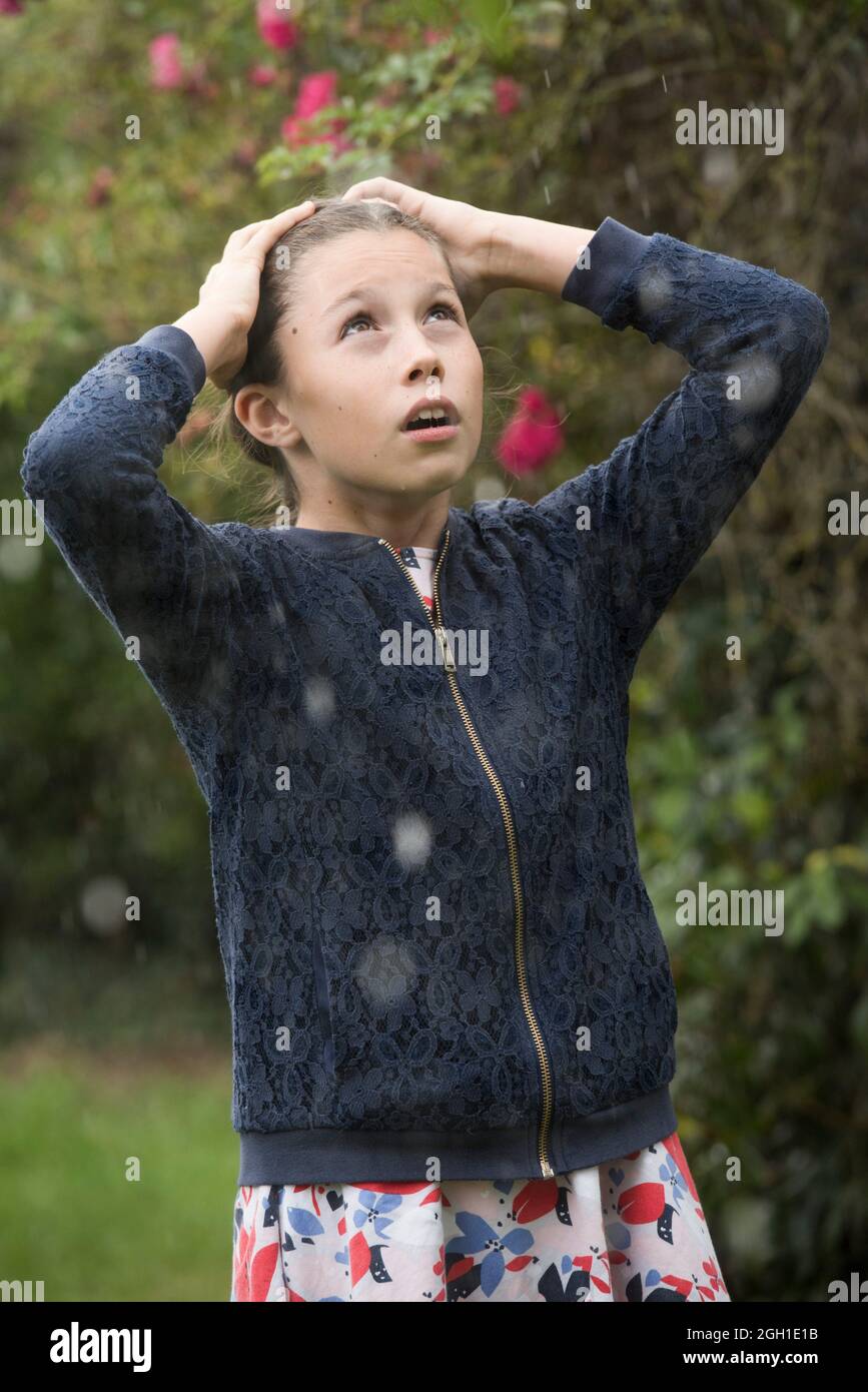 Girl in dress and vest in the rain, France, Europe. Stock Photo