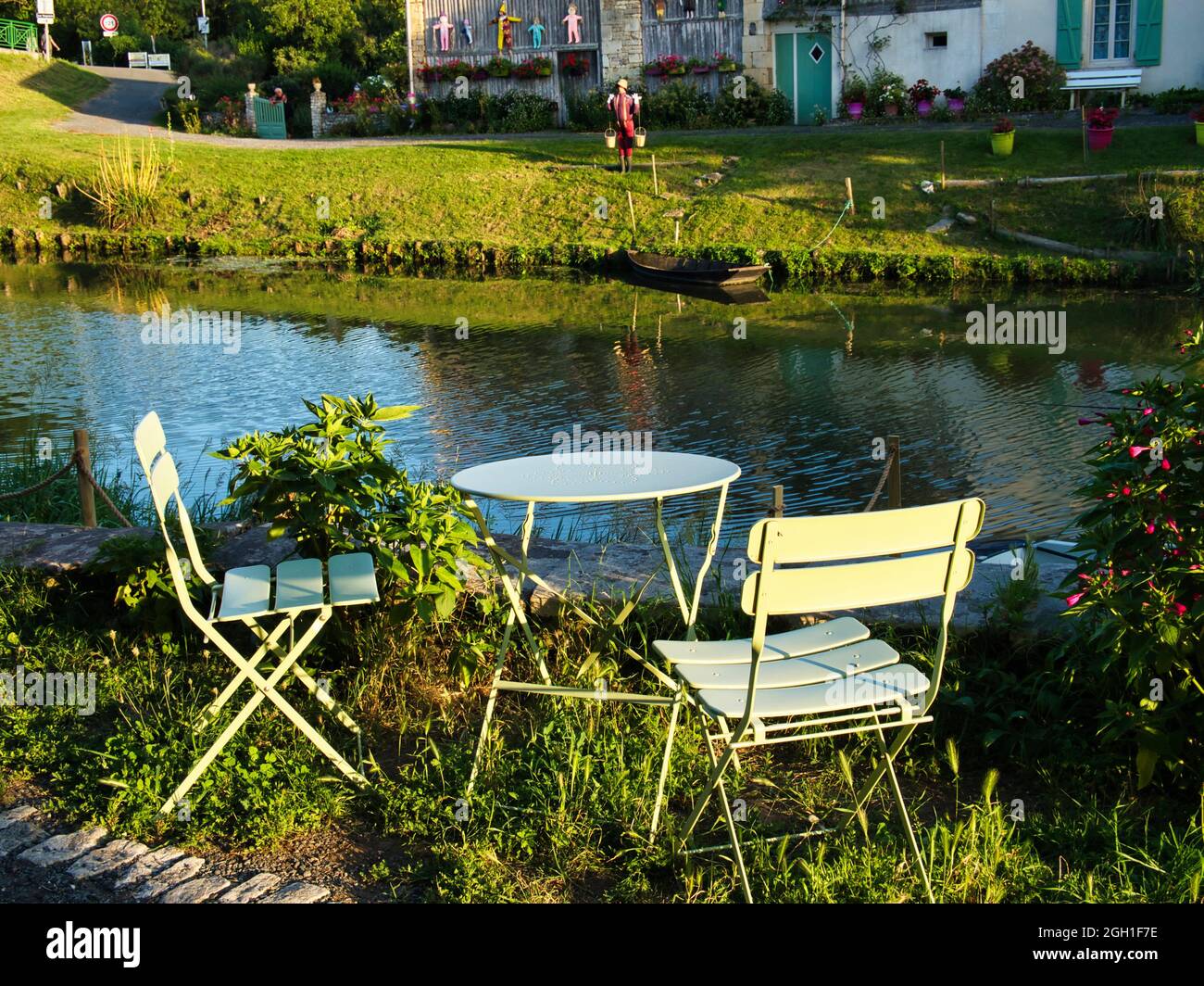 small metal table and chairs on river bank, Damvix, vendee Department, Pays de Loire, France. Stock Photo