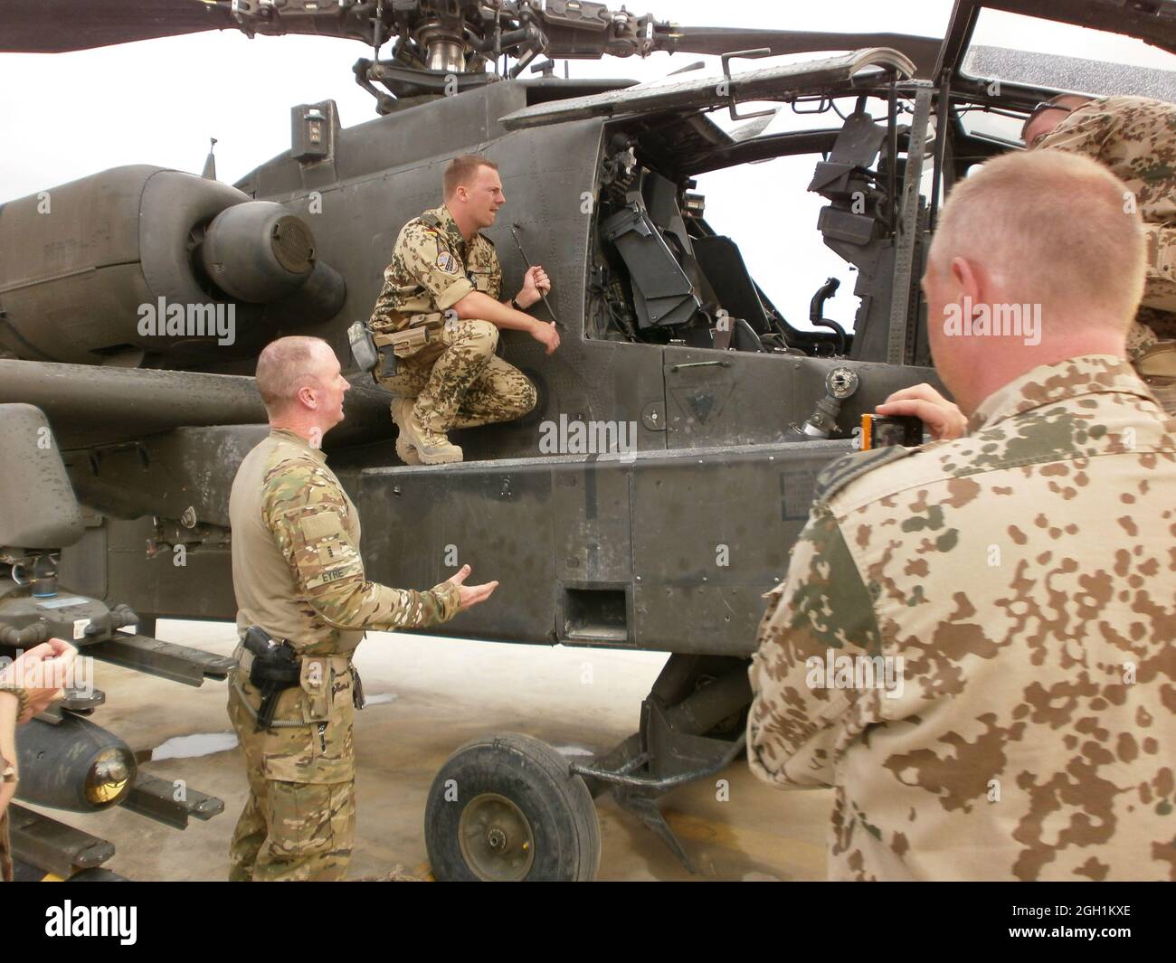 CW4 Ryan Eyre gives a tour and discusses capabilities of the AH-64D Longbow with German and Swedish Air Traffic Control soldiers after a mission.  (Photo by Maj. John C. Crotzer) Stock Photo