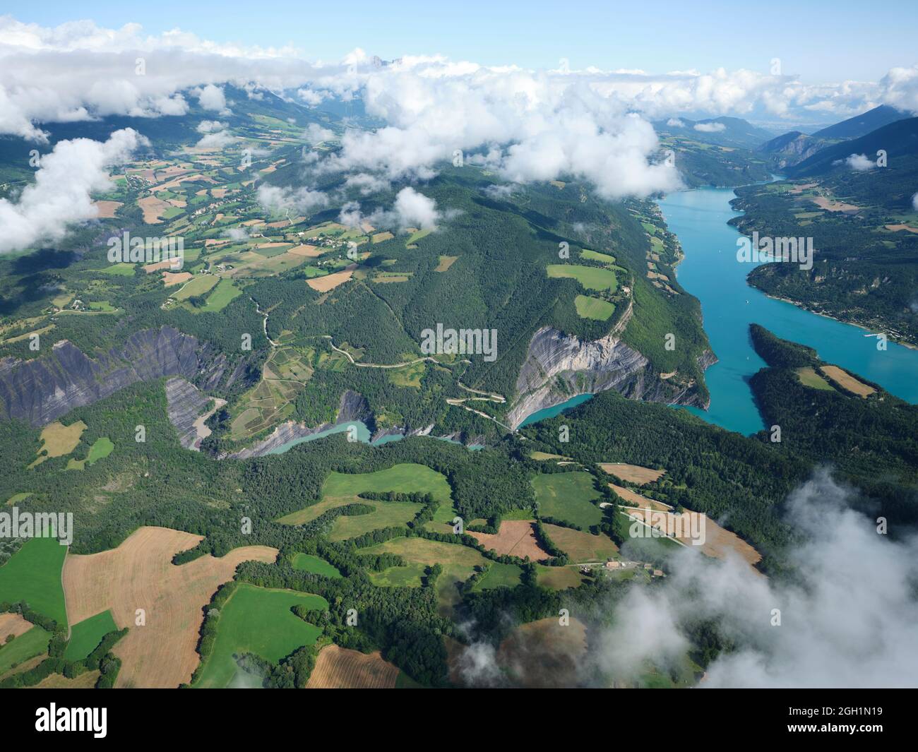 AERIAL VIEW. Lake Monteynard-Avignonet, a reservoir on the Drac Valley and the farmlands of the Trièves Region, Isère, France. Stock Photo