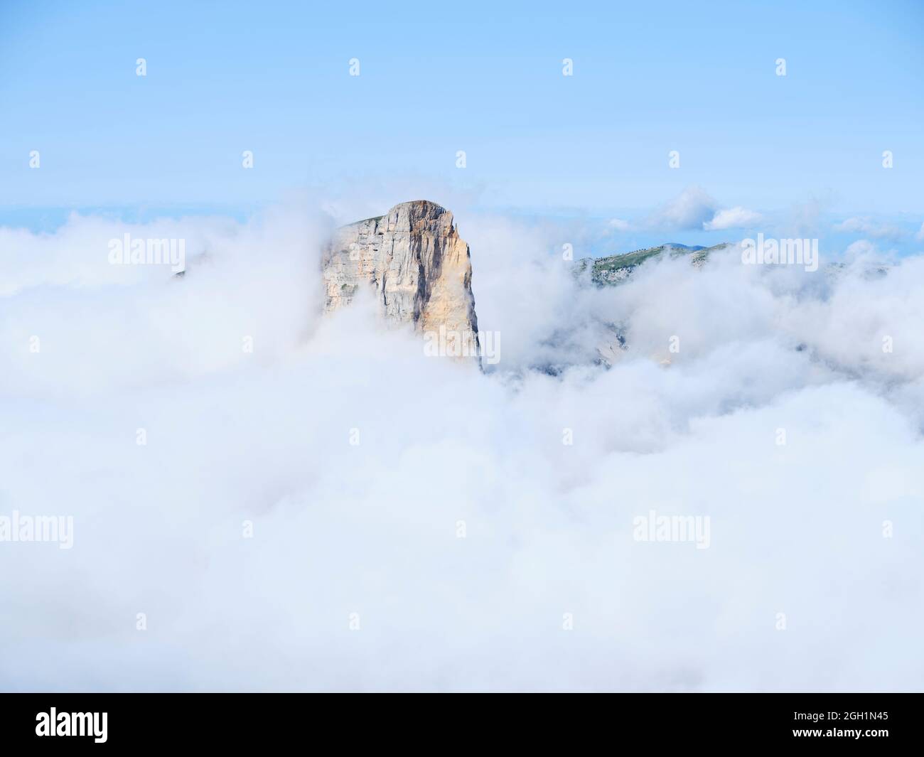 AERIAL VIEW. Mont Aiguille, an isolated limestone butte emerging from a sea of clouds. Saint-Martin de Clelles, Vercors Mountain, Isère, France. Stock Photo