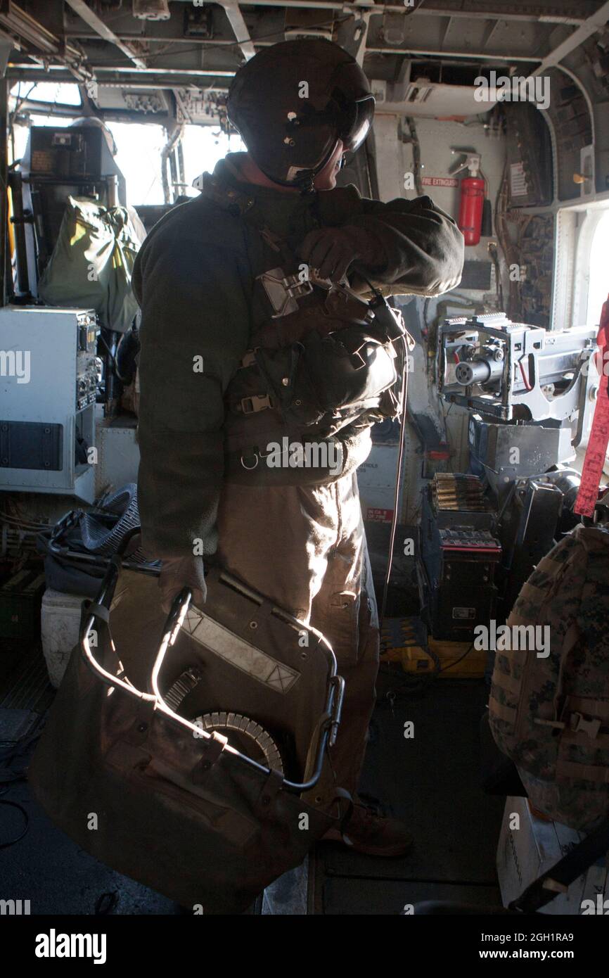 U.S. Marine Corps Gunnery Sgt. Jeremy Miller, crew chief, Marine Heavy Helicopter Squadron 363 (HMH-363), secures equipment after use, Camp Bastion, Helmand province, Afghanistan, Jan. 5. Marines of HMH-363 secure the equipment to ensure accountability and the safeguard of gear. Stock Photo