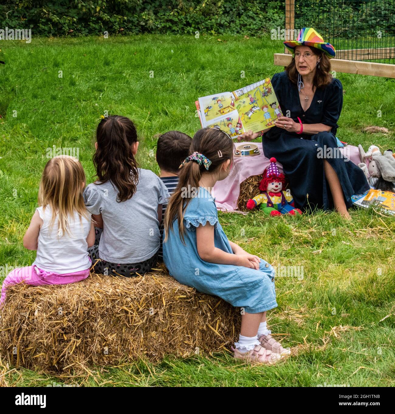 Childrens story time in the park Stock Photo