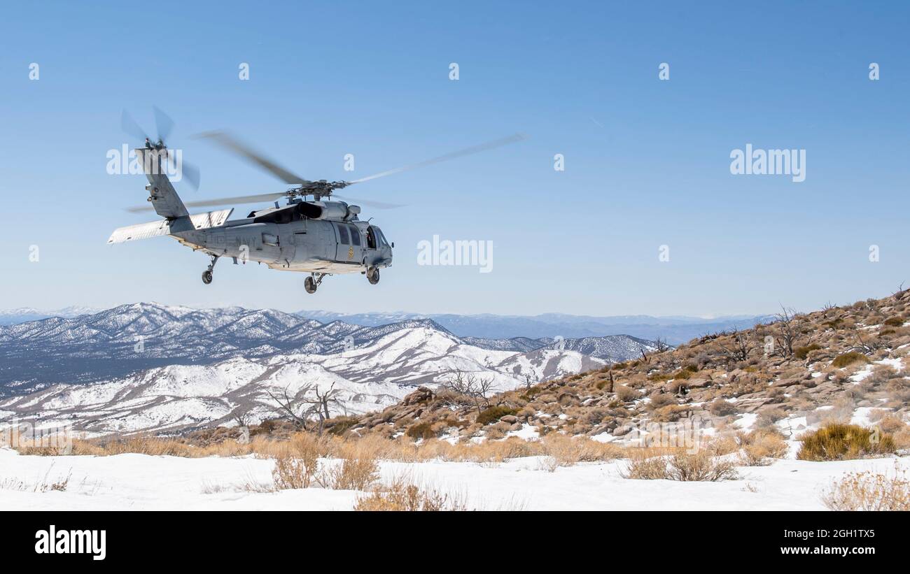 FALLON, Nev. (March 30, 2021) An MH-60S Sea Hawk helicopter assigned to the “Black Knights” of Helicopter Sea Combat Squadron (HSC) 4 conducts a fligh Stock Photo