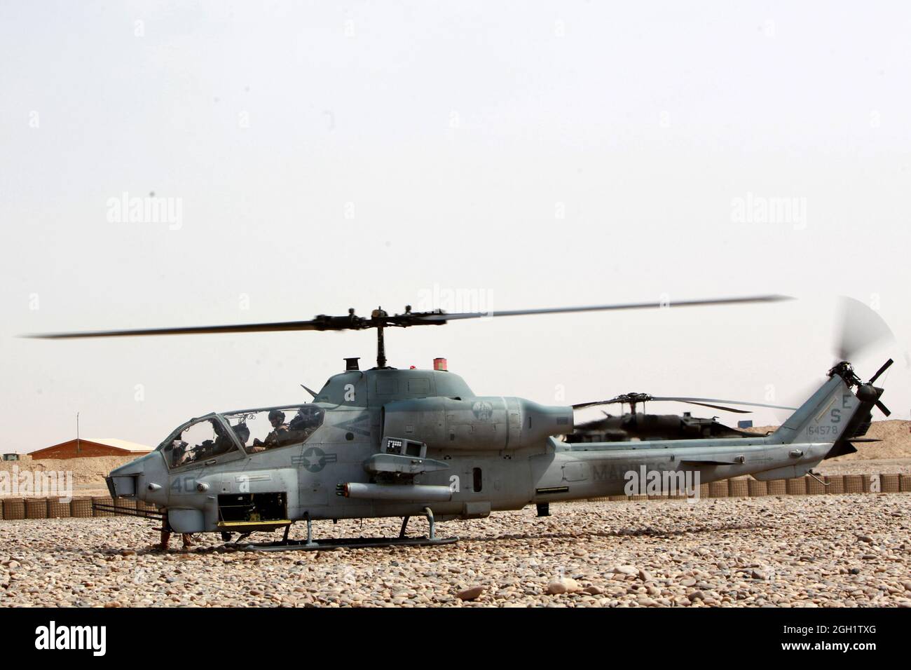 A U.S. Marine Corps AH-1W Cobra helicopter with Marine Light Attack Helicopter Squadron (HMLA) 469 awaits fuel prior to take off to provide aerial reconnaissance for Marines with 3rd Light Armored Reconnaissance (3rd LAR) Battalion in Helmand province, Afghanistan on June 20, 2012. HMLA-469 provided aerial reconnaissance and security for the Marines of 3rd LAR during operation Halberd V to prevent the distribution of contraband in support of counter insurgency operations. Stock Photo