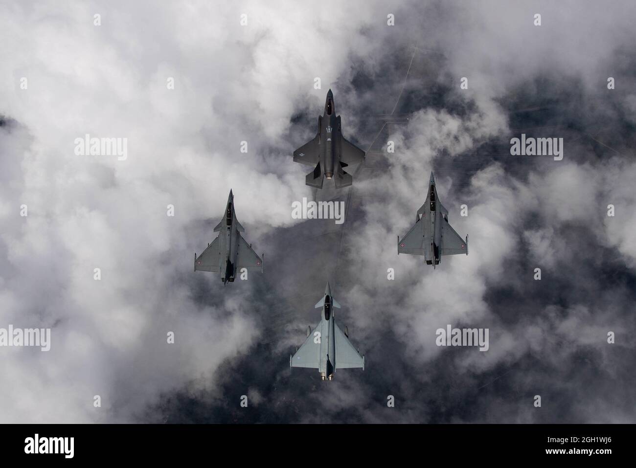 A U.S. Air Force F-35A Lightning II, two Dassault Rafales and a Royal Air Force Eurofighter Typhoon fly in formation May 19, 2021, over France. The fl Stock Photo