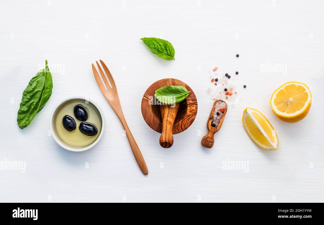 Sweet basil vinaigrette dressing ingredients on white wooden background