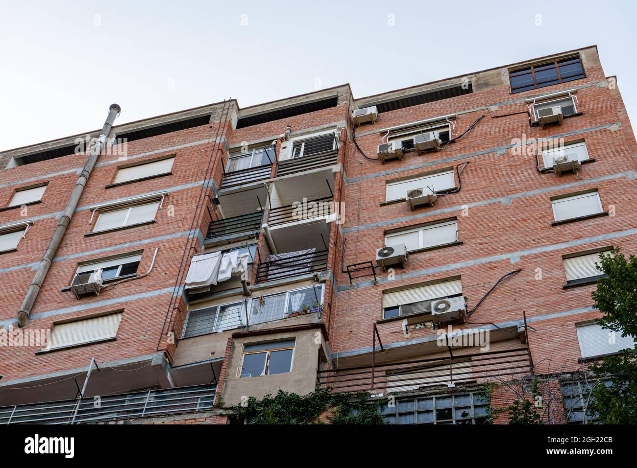 Residential building exterior with balconies and air conditioner outdoor units on the wall Stock
