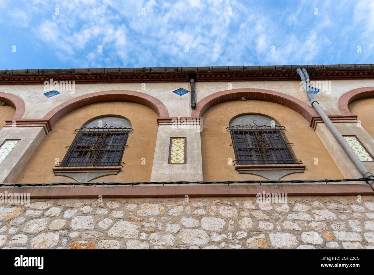 Low angle shot of an old abandoned building exterior with arched style ...