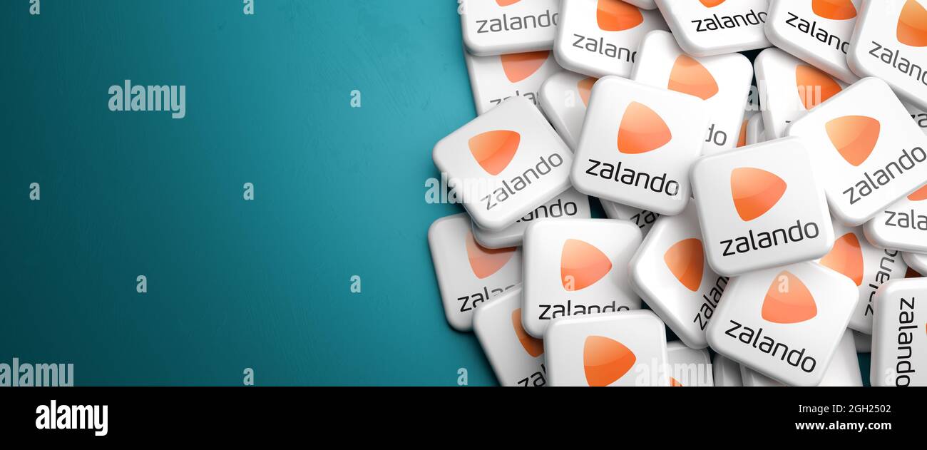 Logos of the e-commerce company Zalando (fashion and lifestyle - member of DAX 40 as of Sept 2021) on a heap on a table. Copy space. Web banner format Stock Photo
