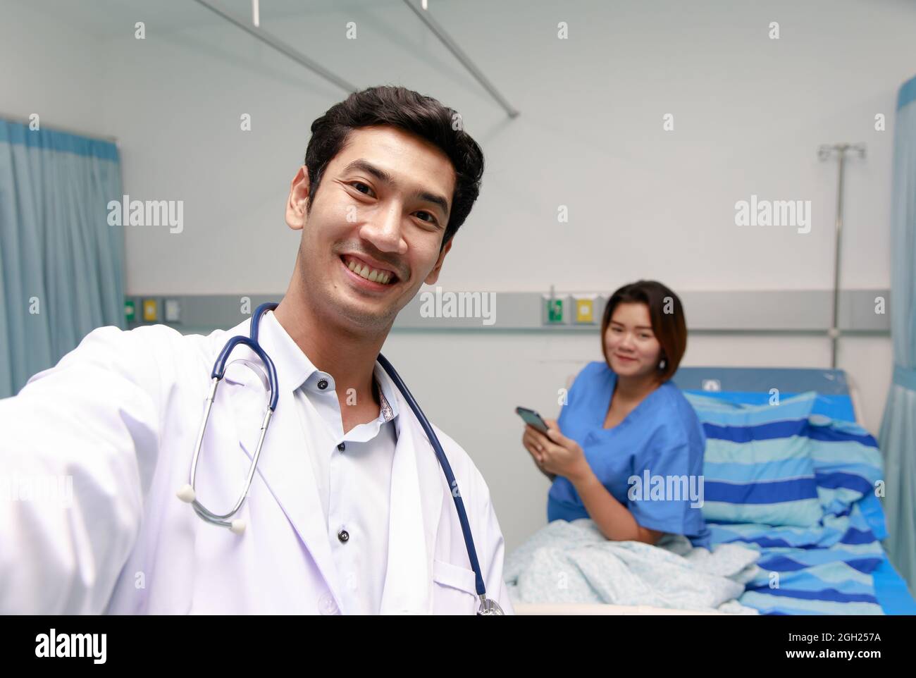 Young and friendly smart doctor smile and looking at camera during 