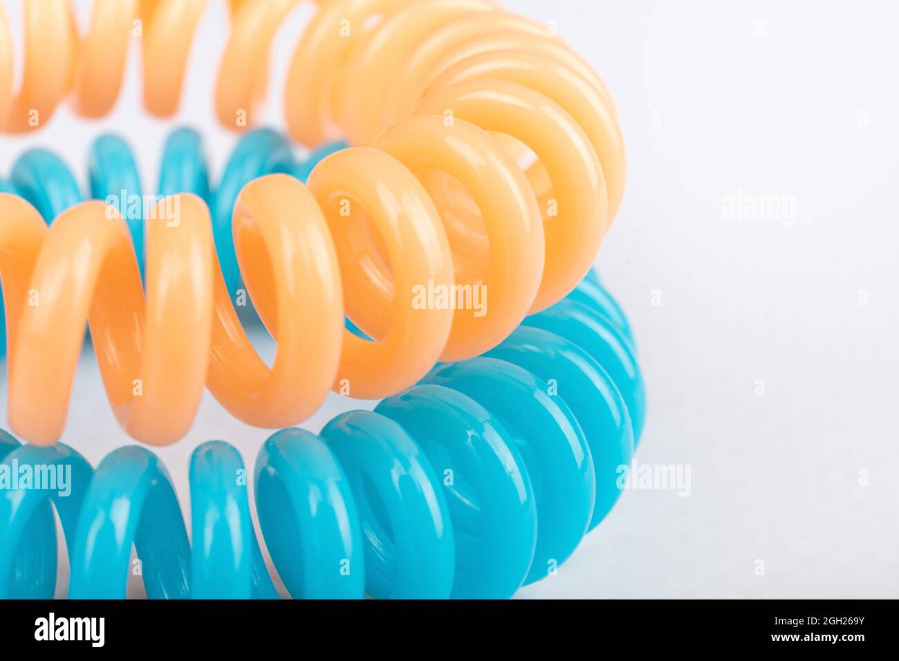 multicolored spiral hair ties close up on white background. Stock Photo