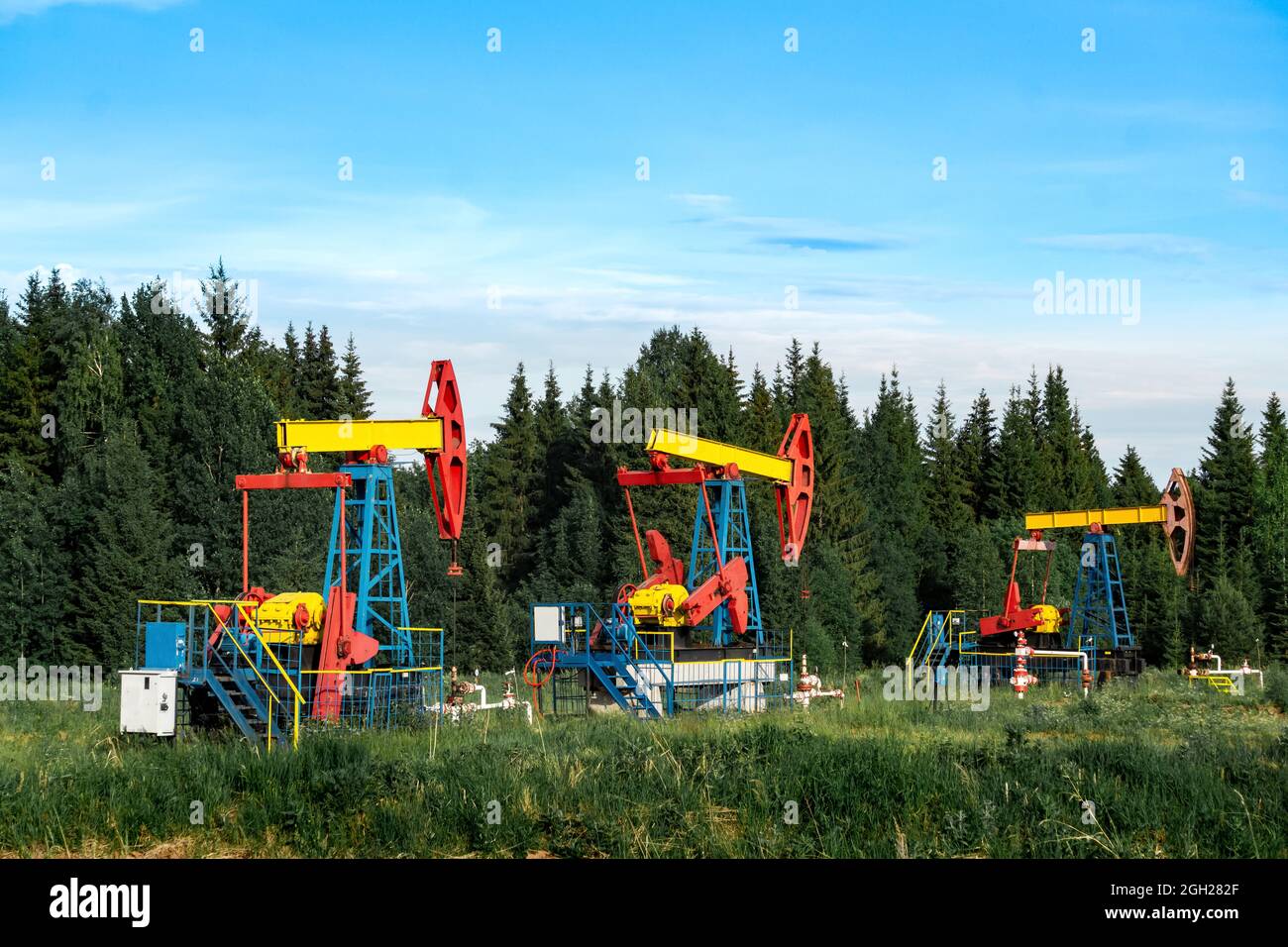 oil pumpjacks in a clearing in the forest Stock Photo