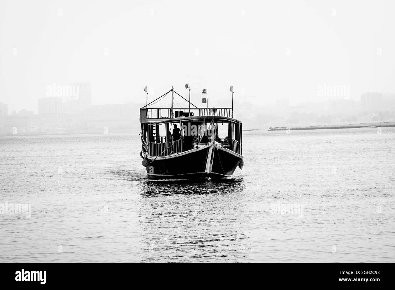 DOHA, QATAR - Mar 01, 2019: A closeup shot of a small boat, swimming in the waters of The Doha Corniche in a waterfront Qatar, Doha Stock Photo