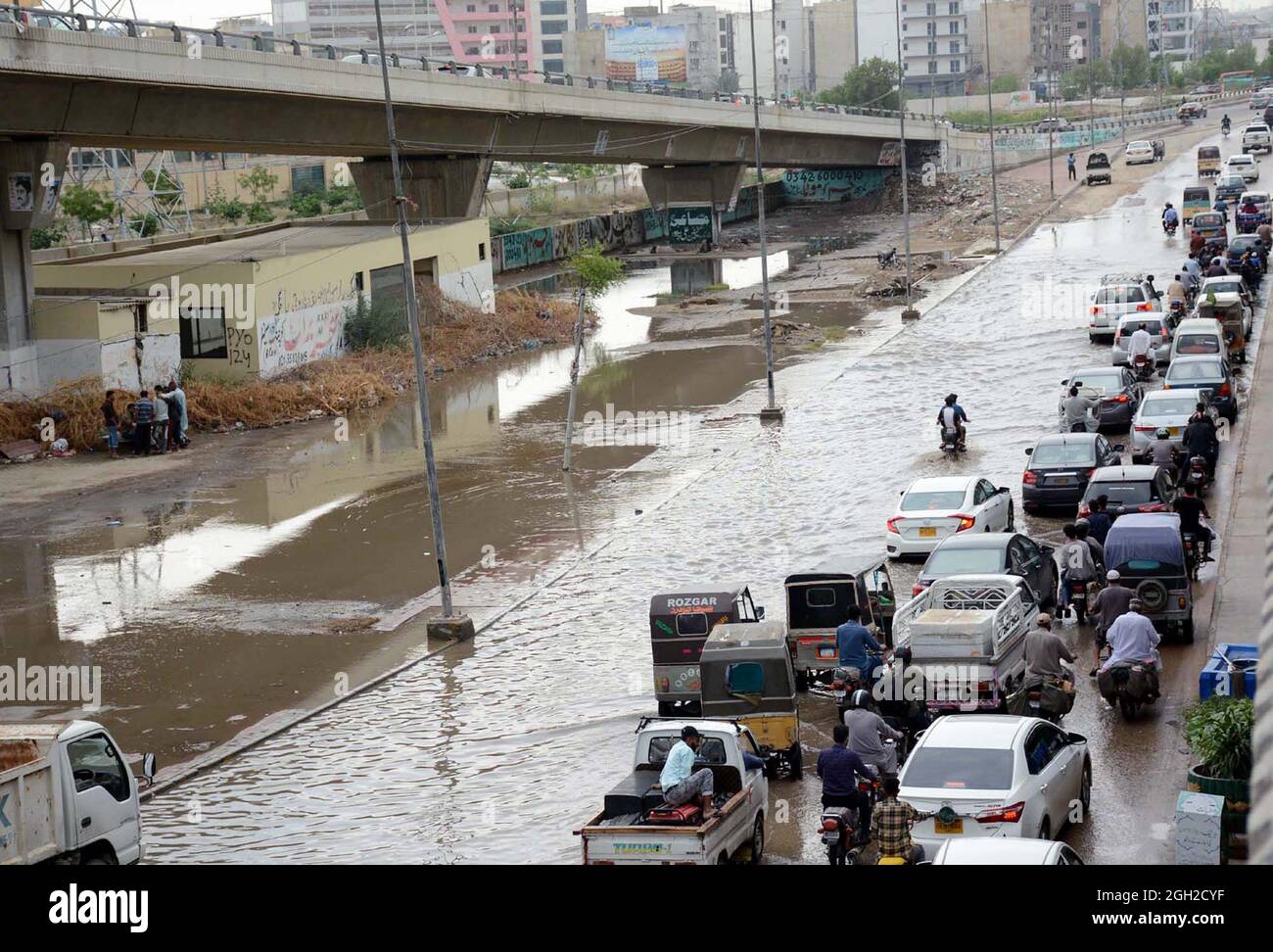 Commuters are facing difficulties in transportation due to stagnant rainwater due to poor sewerage system caused by heavy downpour of monsoon season, creating problems for residents, showing negligence of concerned authorities, located on Korangi area of Karachi on Saturday, September 04, 2021. Stock Photo