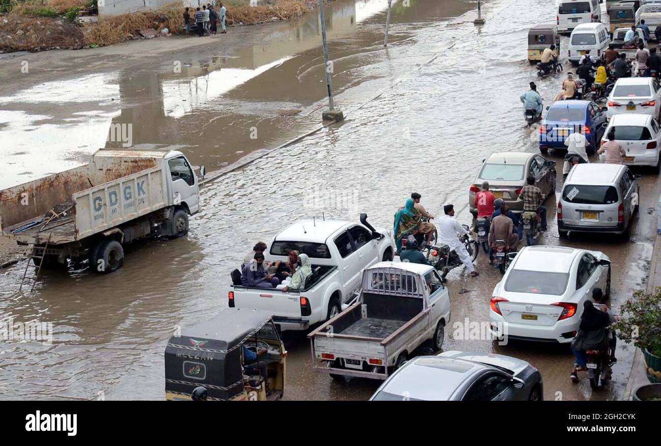 Commuters are facing difficulties in transportation due to stagnant rainwater due to poor sewerage system caused by heavy downpour of monsoon season, creating problems for residents, showing negligence of concerned authorities, located on Korangi area of Karachi on Saturday, September 04, 2021. Stock Photo