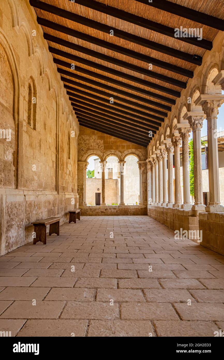 August 10, 2021 - Abbey of Santa Maria a Cerrate, Puglia, Salento, Lecce - The portico at the side of the church, shady and cool, with arches and colu Stock Photo