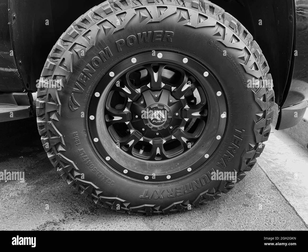 FRESNO, UNITED STATES - Aug 15, 2021: A closeup of a Venom Power tire with black custom rims on a truck Stock Photo