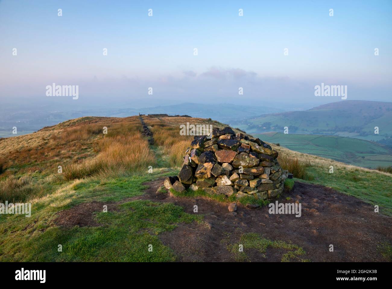 Cairn on the summit of South Head near Hayfield in the High Peak, Derbyshire, England. A view from this hilltop on a beautiful autumn morning. Stock Photo