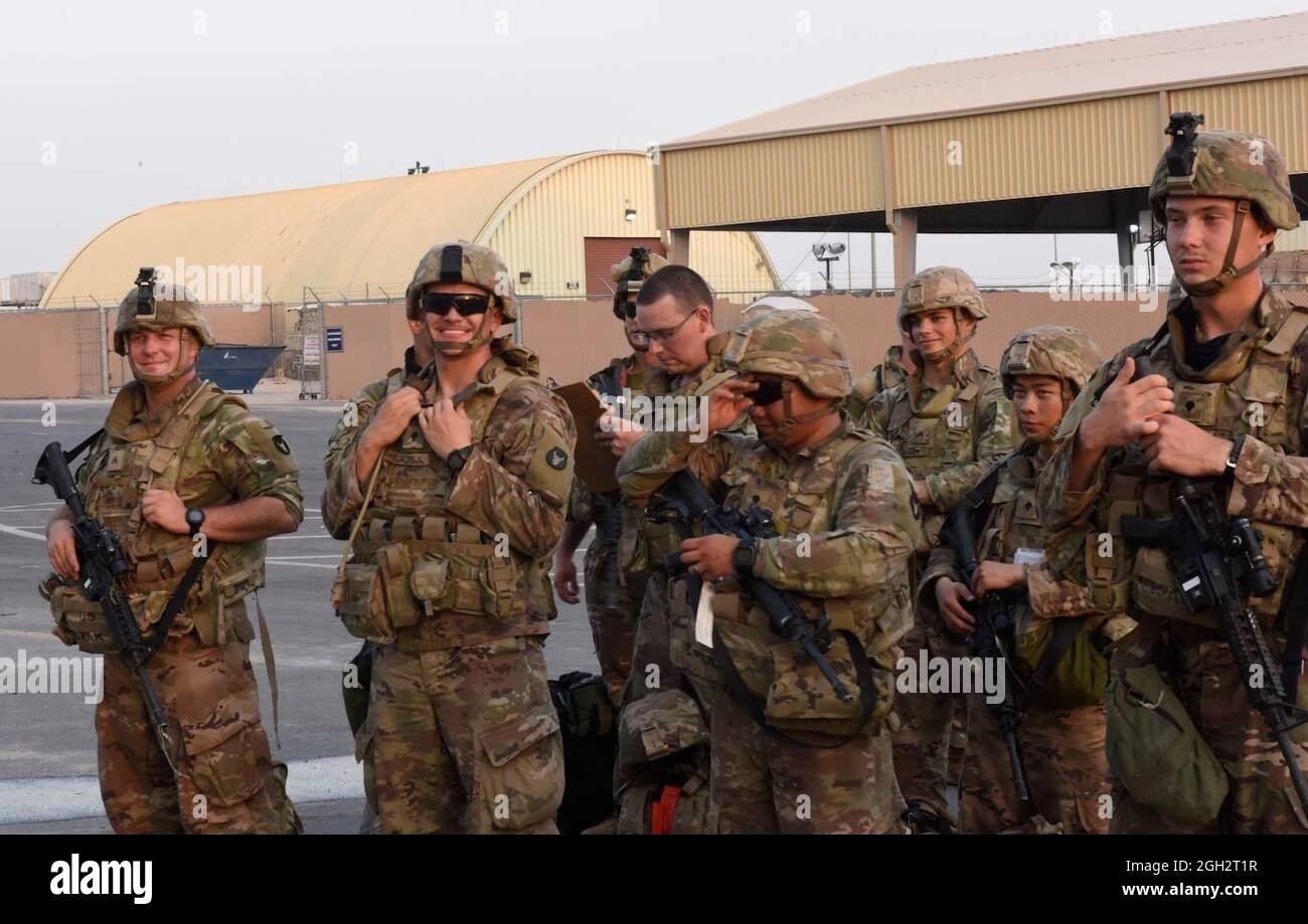 Soldiers from the Minnesota-based 34th Infantry Division smile shortly after their flight from Kabul, Afghanistan, landed Aug. 31, 2021, in Kuwait. Known as the Red Bulls - the National Guard Soldiers were some of the last American servicemembers to leave Afghanistan. Stock Photo