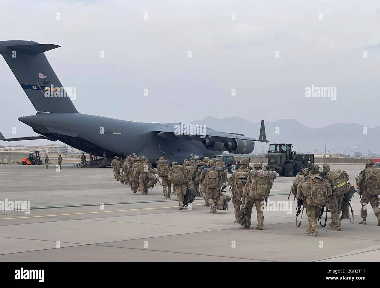 Soldiers from the Minnesota-based 34th Infantry Division prepare to enter a military aircraft Aug. 31, 2021, in Kabul, Afghanistan, for their flight to Kuwait. Known as the Red Bulls - the National Guard Soldiers were some of the last American servicemembers to leave Afghanistan. Stock Photo