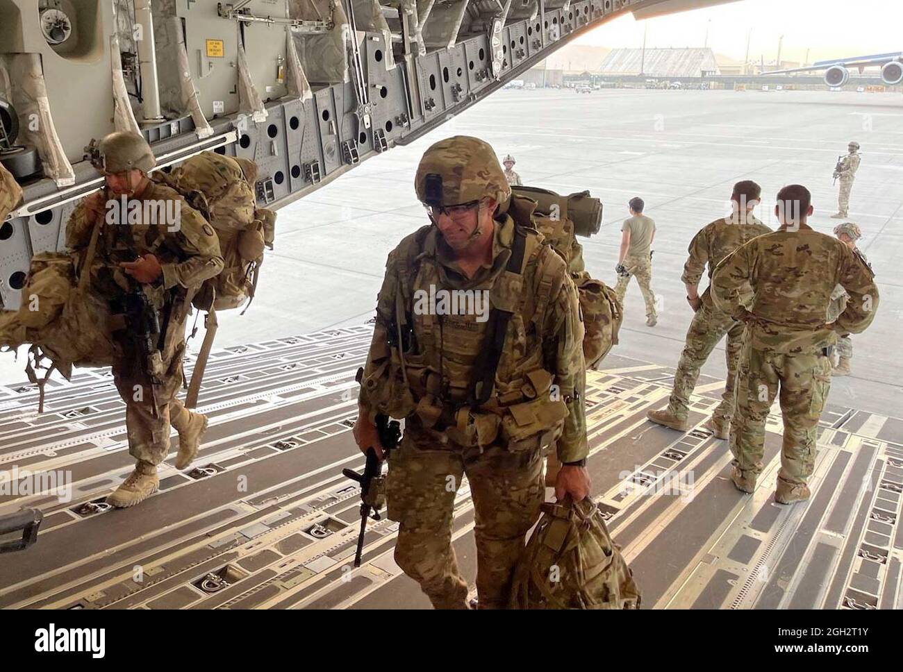 Soldiers from the Minnesota-based 34th Infantry Division board a military aircraft Aug. 31, 2021, for their flight from to Kuwait from Kabul, Afghanistan. Known as the Red Bulls - the National Guard Soldiers were some of the last American servicemembers to leave Afghanistan. Stock Photo