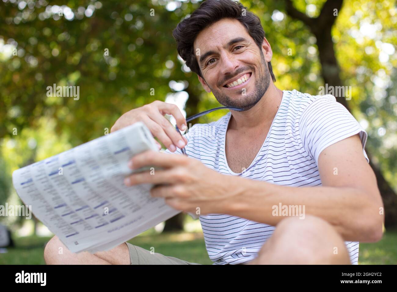 photo of attractive bearded man reading newspaper Stock Photo - Alamy