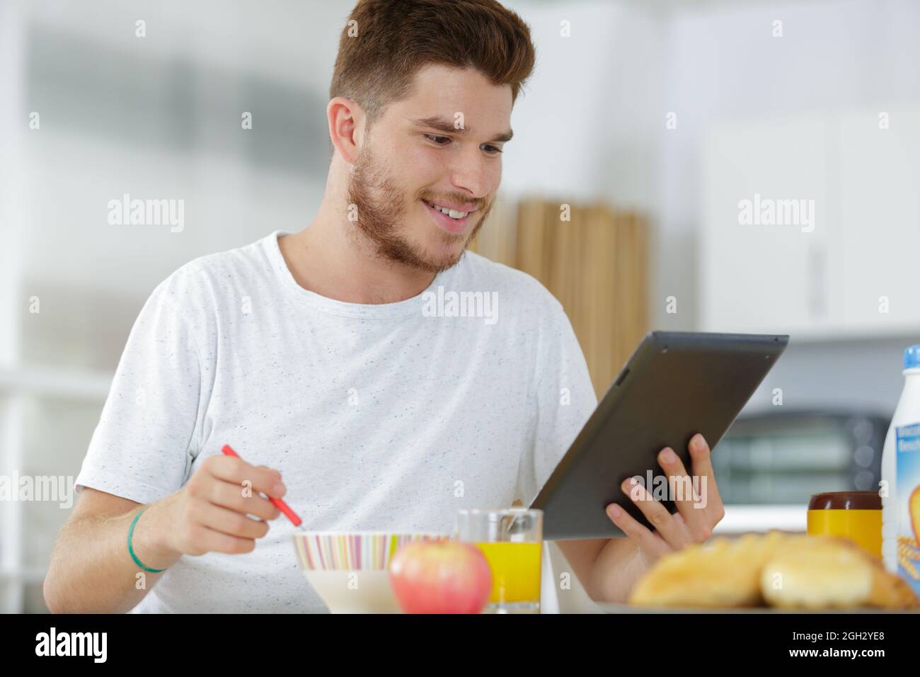 happy young man using digital tablet computer Stock Photo