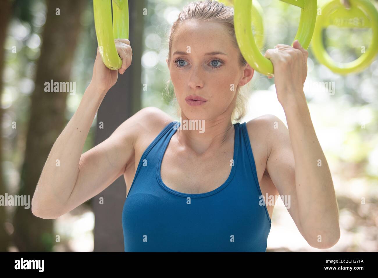 fit girl training abs by raising legs on bar Stock Photo Alamy