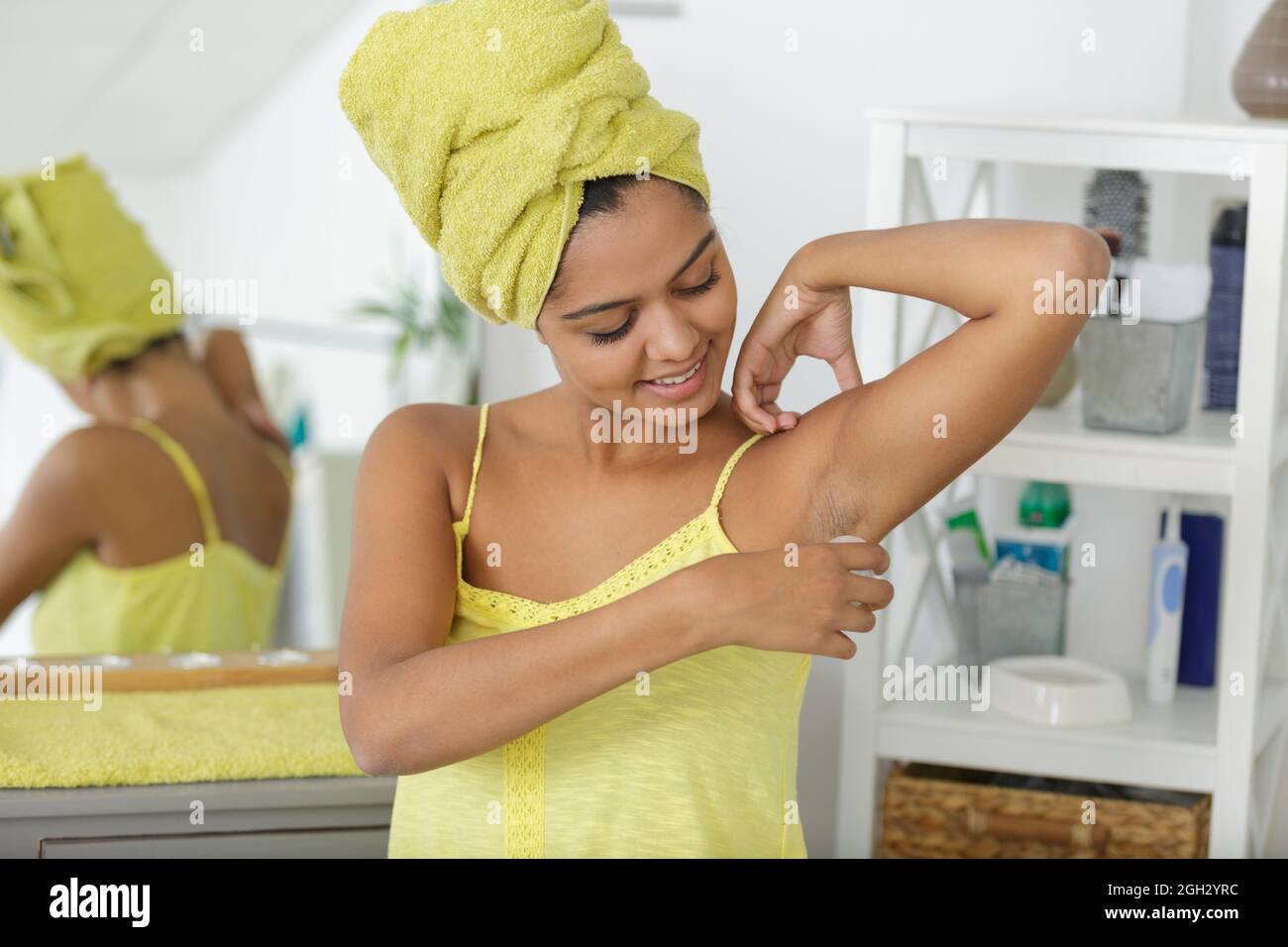 woman puts deodorant on armpits Stock Photo Alamy