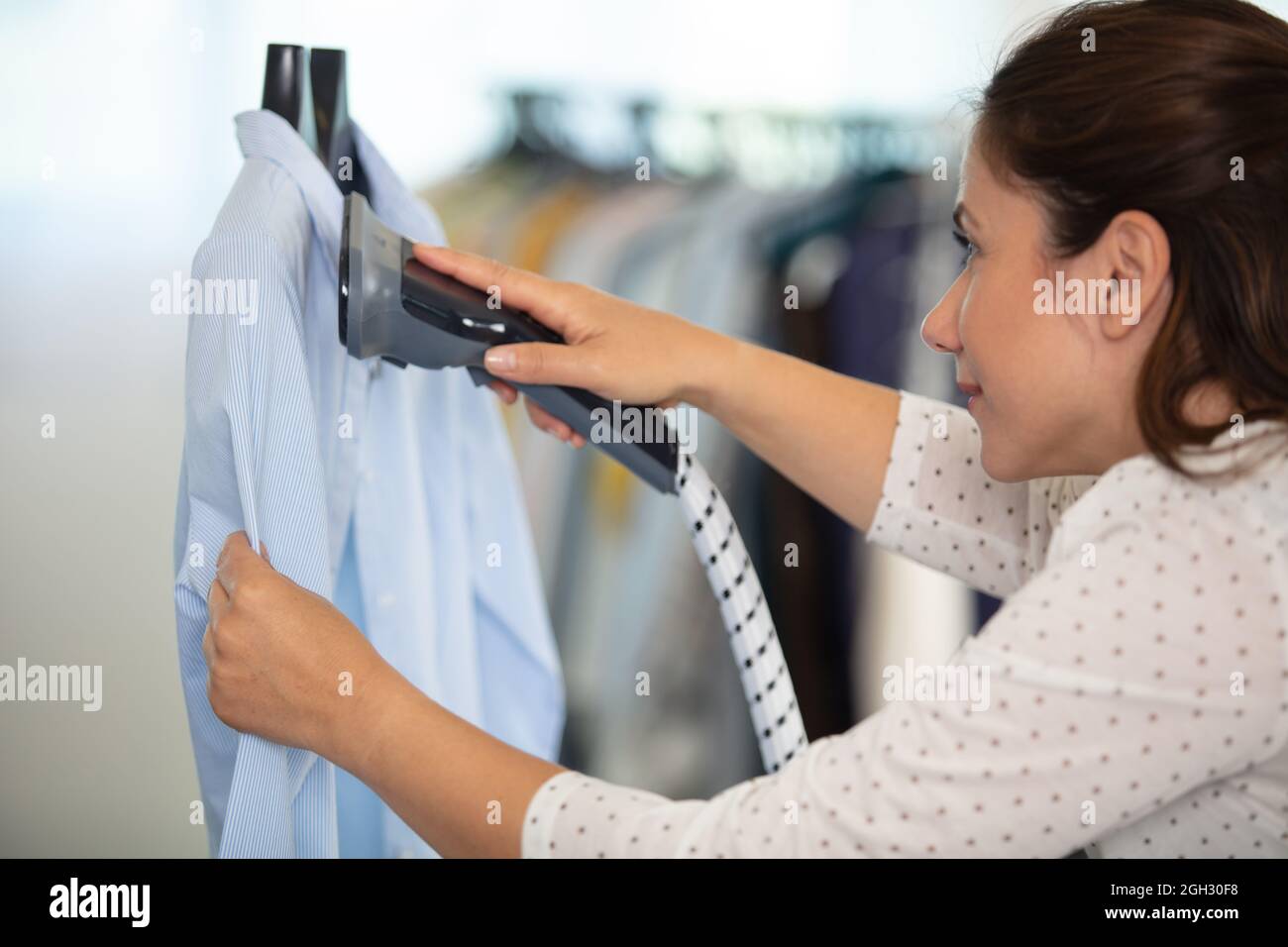 woman woman ironing using a steamer Stock Photo Alamy
