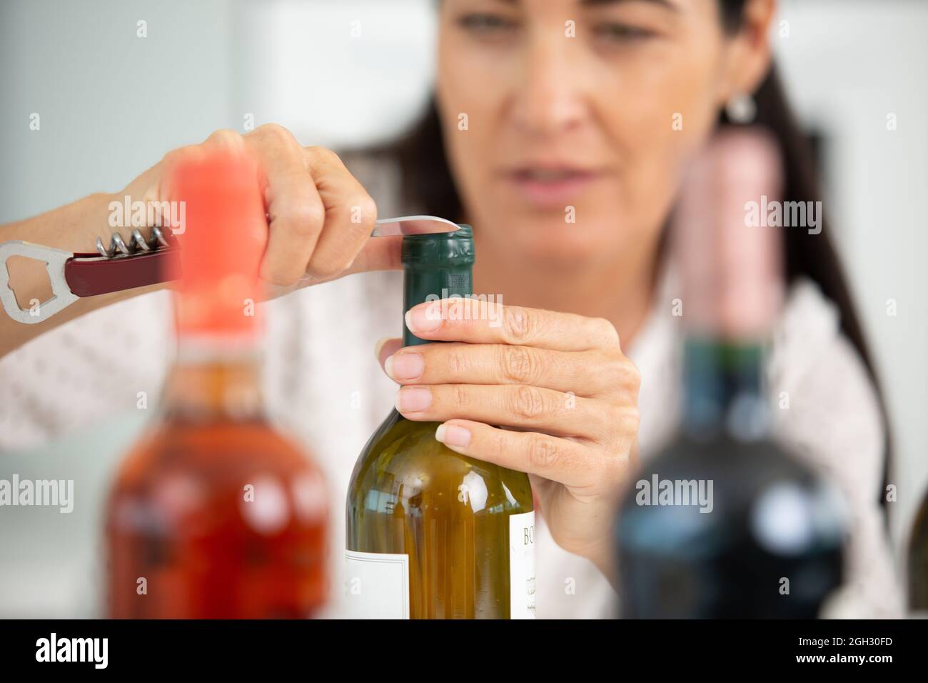 portrait of smiling female wine maker in wine cellar Stock Photo