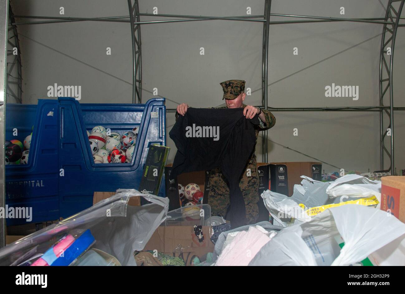 U.S. Marine Corps Maj. Taylor Reeves with Combat Logistic Regiment 2, a Portland, Oregon native, helps move various items donated by the Muslim Association of Virginia, Masjid Noor on Marine Corps Base Quantico, Virginia, Sept. 1, 2021. The Department of Defense, through U.S. Northern Command, and in support of the Department of Homeland Security, is providing transportation, temporary housing, medical screening, and general support for at least 50,000 Afghan evacuees at suitable facilities, in permanent or temporary structures, as quickly as possible. This initiative provides Afghan personnel Stock Photo