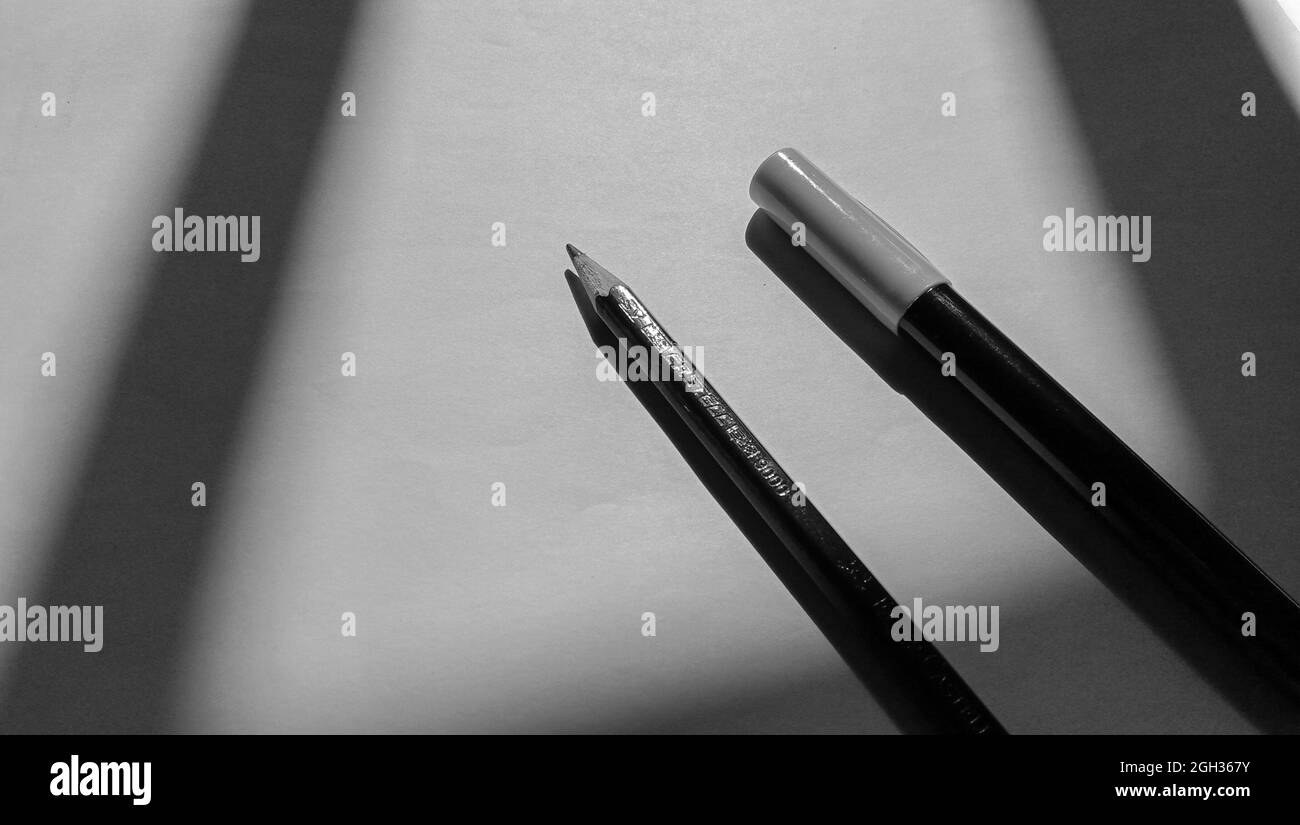 View of a marker and a pencil on the paper in grayscale Stock Photo Alamy