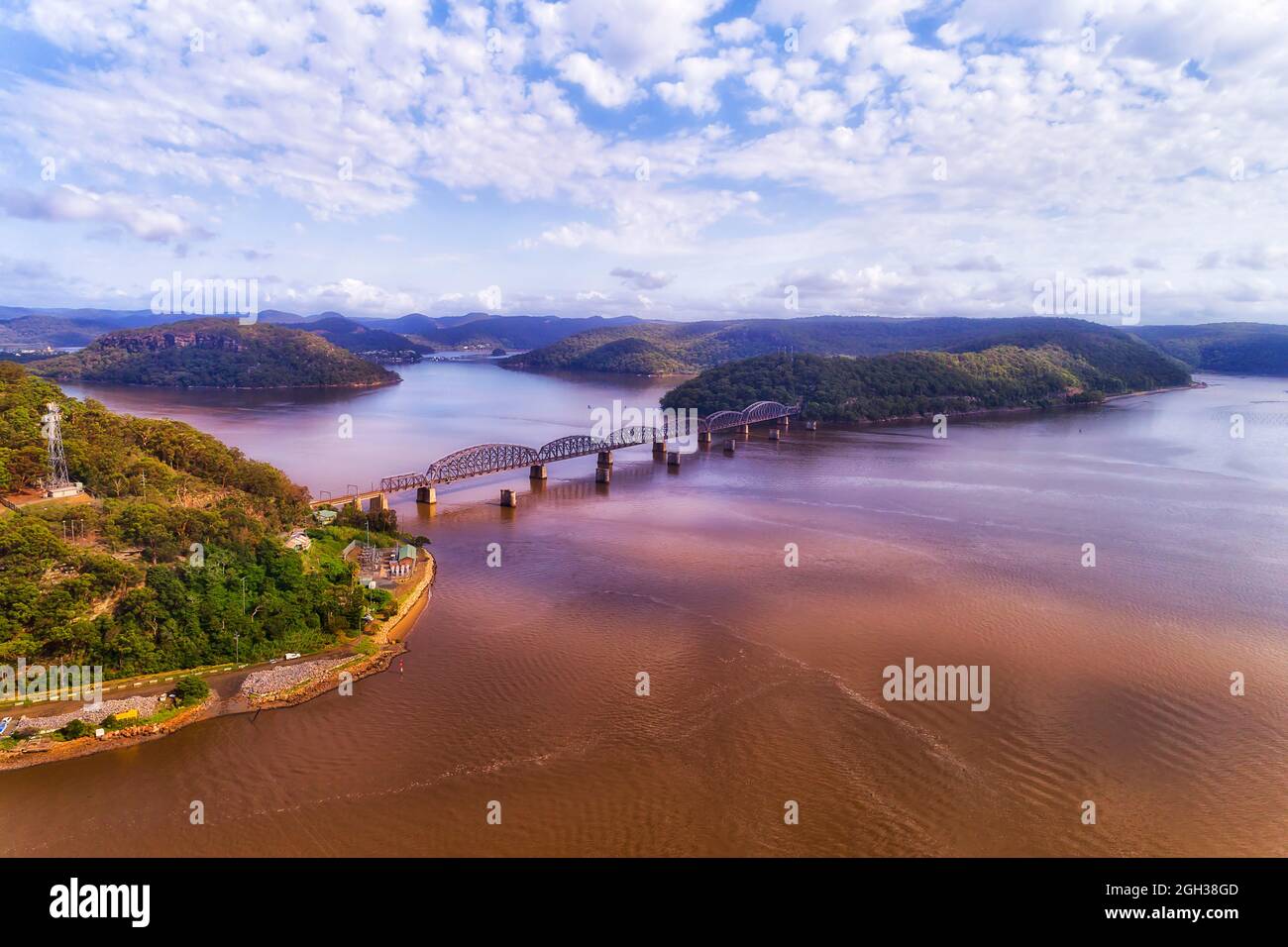Hawkesbury river of Greater Sydney to the Central coast with railway bridge - aerial landscape. Stock Photo